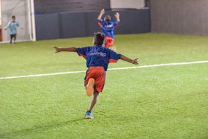 A happy kid celebrating after scoring a goal