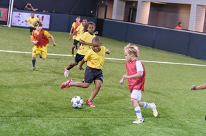 Kids playing on a Footfive field.