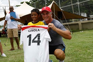 David Ginola posing for a photo with a boy