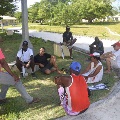 People sitting under a tree in Agalega